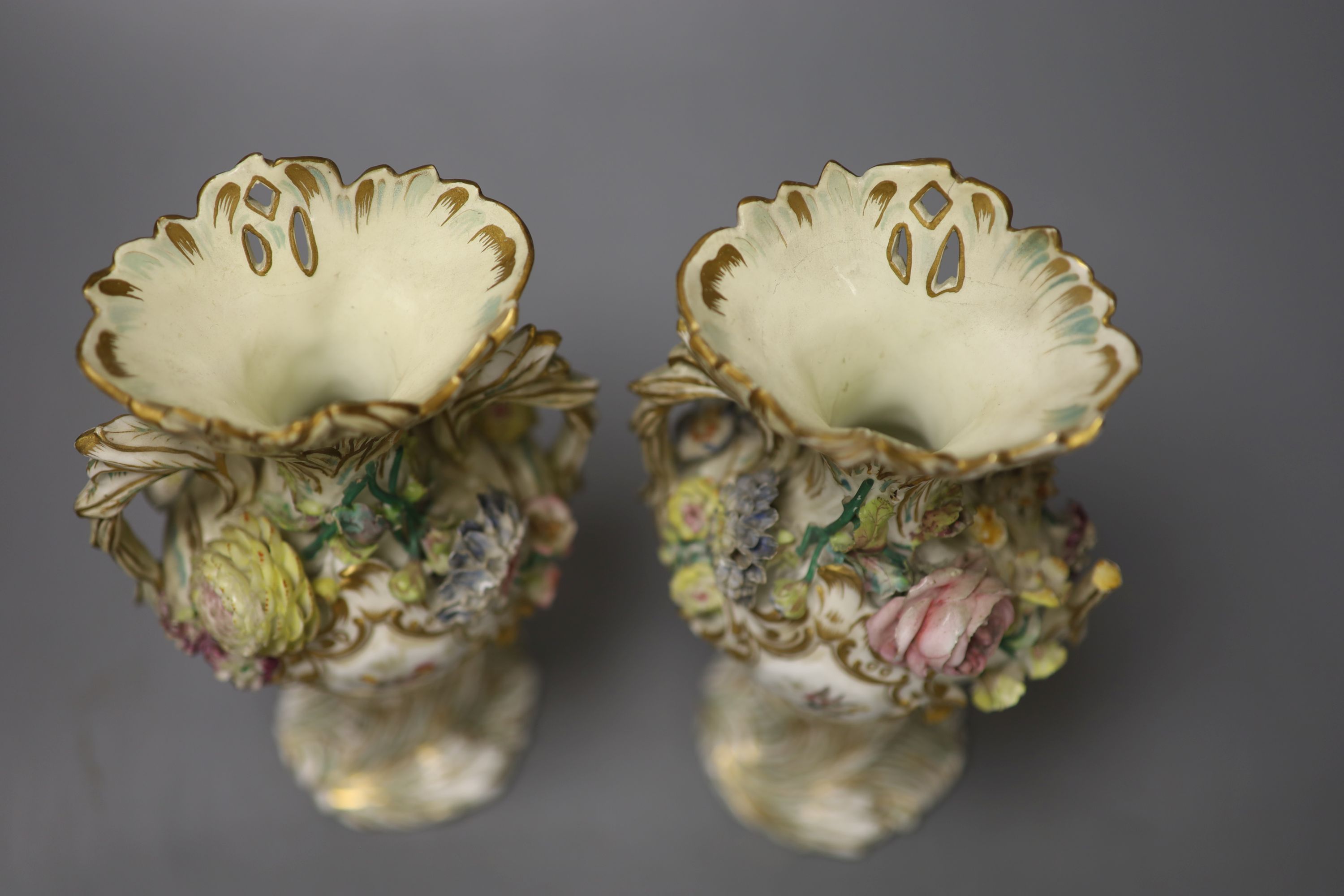 An English porcelain two handled green ground vase and a pair of floral encrusted vases, 20cm